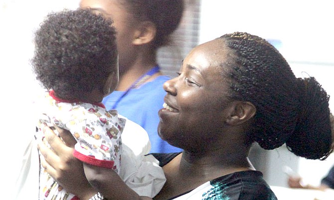 All smiles after the five people - including eight-month-old Andrew Gibson - were rescued safely after the plane they were on board ditched in waters off New Providence on Monday. 
Photos: Marine Seaman Collison Ingraham/RBDF