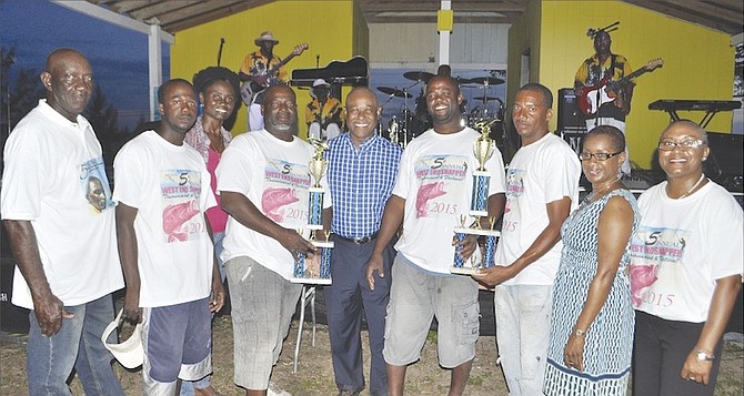 TOURNAMENT WINNERS - Old Bahama Bay came out on top once again during the West End 5th Annual Snapper Fishing Tournament on Saturday. The crew is seen receiving their trophy from Minister of Tourism and Member of Parliament for West Grand Bahama, Obie Wilchcombe. Also seen in the photo (second from right) is Betty Bethel, director of tourism for Grand Bahama, Brenda Colebrook, administrator for West Grand Bahama (third from left) and Elaine Smith, of the Ministry of Tourism (right).