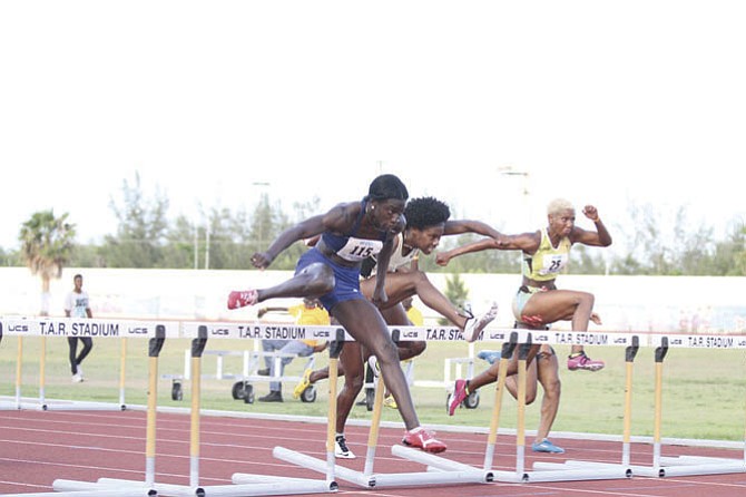 
SHOWN (l-r) are Adanaca Brown, Devynne Charlton and Lavonne Idlette of the Dominican Republic in the hurdles.
Photo by Tim Clarke/Tribune Staff
