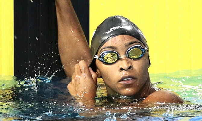 Arianna Vanderpool-Wallace watches for her time after her heat in the women's preliminary 100-metre freestyle at the Pan Am Games. She went on to win the bronze in the final. (AP Photo/Mark Humphrey)
