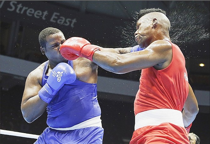 Lenier Pero, right, of Cuba, fights Kieshno Major, of the Bahamas, in a superheavyweight bout at the Pan Am Games boxing competition on Sunday, July 19, 2015, in Oshawa, Ontario. 
                                                                                                                                                                
(AP Photo/Mark Humphrey)
