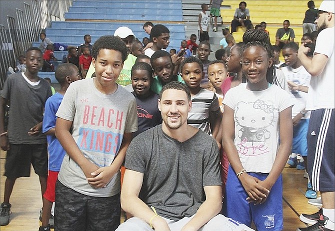 Klay Thompson, of the NBA champions Golden State Warriors, is surrounded by young fans yesterday during the Jeff Rodgers Basketball Camp at Kendal Isaacs Gym.
Photo by Shawn Hanna/Tribune Staff
