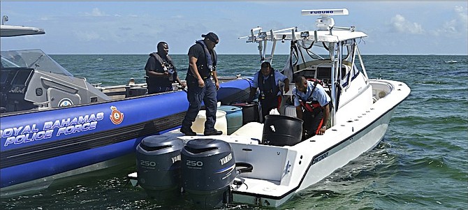 Officers in Abaco with the stolen vehicle they intercepted near the Berry Islands with the assistance of the US Coast Guard. 
