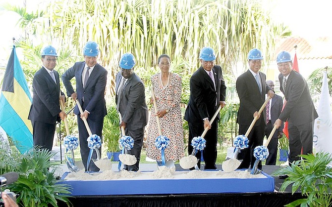 Prime Minister Perry Christie, Governor General Dame Margueritte Pindling, Deputy Prime Minister Philip ‘Brave’ Davis and officials from China Construction American (CCA) and The Pointe - including The Pointe president Daniel Liu (far left) and chairman of the CCA Ning Yuan (second left), at yesterday’s groundbreaking ceremony. The resort presented cheques, worth $10,000 each, to the Bain and Grants Town Association, a historical association, and a beach soccer programme for local youth.
Photo: Tim Clarke/Tribune staff
