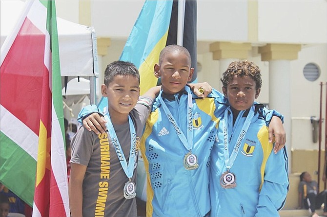 MEDAL HAUL: Shown (l-r) are Doron of Suriname, Marvin Johnson and Amauri Bonamy on the medal podium during the XXI Goodwill Swim Meet at the Dr Joao Havelange Centre of Excellence swimming facility in Trinidad and Tobago.

