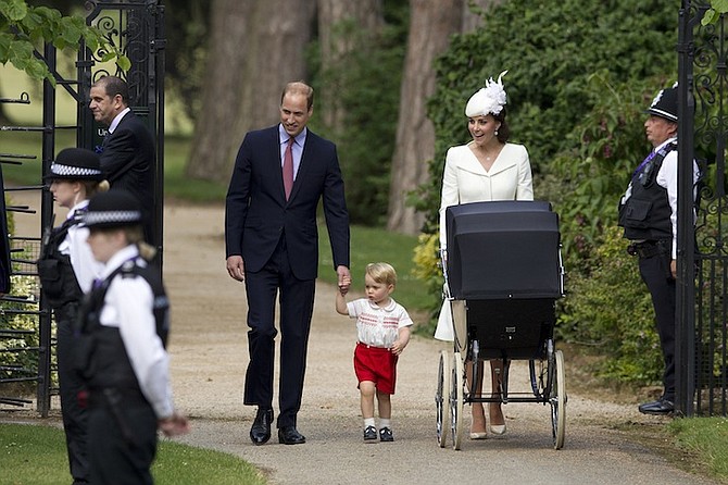Britain's Prince William, Kate, the Duchess of Cambridge, and their son, Prince George, walk with their daughter Princess Charlotte in a pram. (AP)
