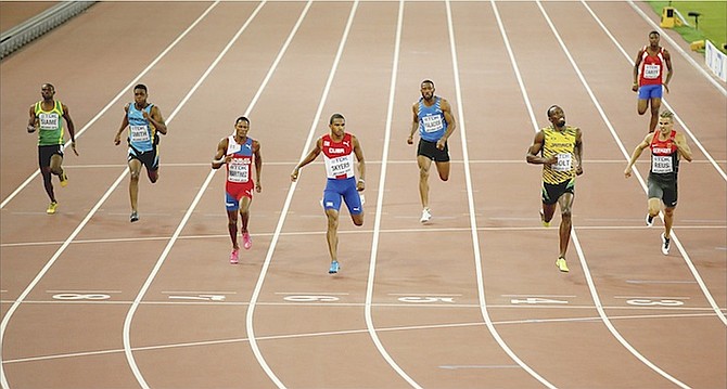 TERAY SMITH (second from left), of the Bahamas, competes in the first round of the 200 metres yesterday at the 15th IAAF World Championships in Beijing, China. 