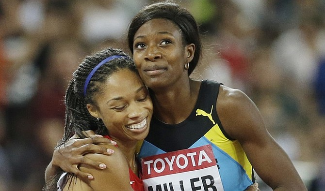 United States' Allyson, left, is embraced by silver medalist Shaunae Miller after the women's 400m final at the World Athletics Championships at the Bird's Nest stadium in Beijing. (AP)