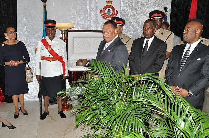 Prime Minister Perry Christie, Immigration Minister Fred Mitchell and Tourism Minister Obie Wilchcombe at the lying in repose of Sir Albert Miller at the Grand Bahama Police Headquarters on Friday. Photo: Vandyke Hepburn/BIS