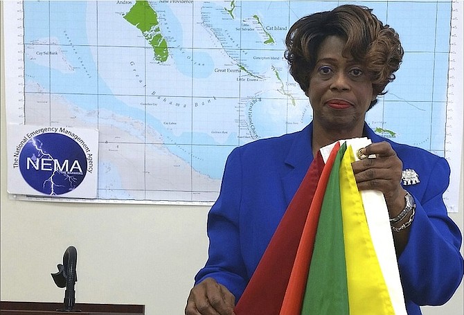Chrystal Glinton, First Assistant Secretary at the National Emergency Management Agency, explains what the colours of the flags mean during a disaster. Photo: NEMA

