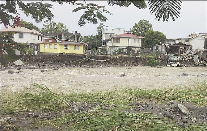 A river overflows, affecting some homes along its banks, during Tropical Storm Erika in Roseau, Dominica. Streets across Dominica turned into fast-flowing rivers that swept up cars as the storm pummeled the eastern Caribbean island. 