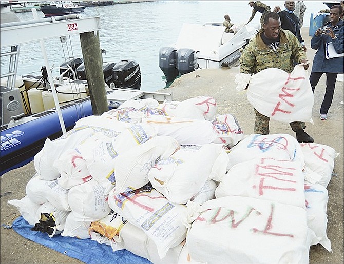 Officers unloading a major drug seizure that occured overnight in the Ragged Island chain, after arriving at the Police Marine Base, Bay Street, yesterday. Photo: Shawn Hanna/Tribune Staff
