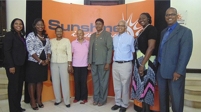Sunshine Insurance vice-pesident of operations Shelly Wilson (left) poses with the beneficiaries of Sunshine Insurance Race Weekend and vice-president of development Dwayne Swaby (right). 
Photos: Chakita Archer

