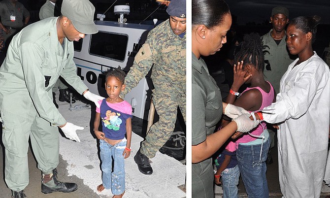 The migrants were brought in by the US Coast Guard to Freeport, Grand Bahama, last night and handed over to Bahamian Immigration authorities. Photos by Vandyke Hepburn