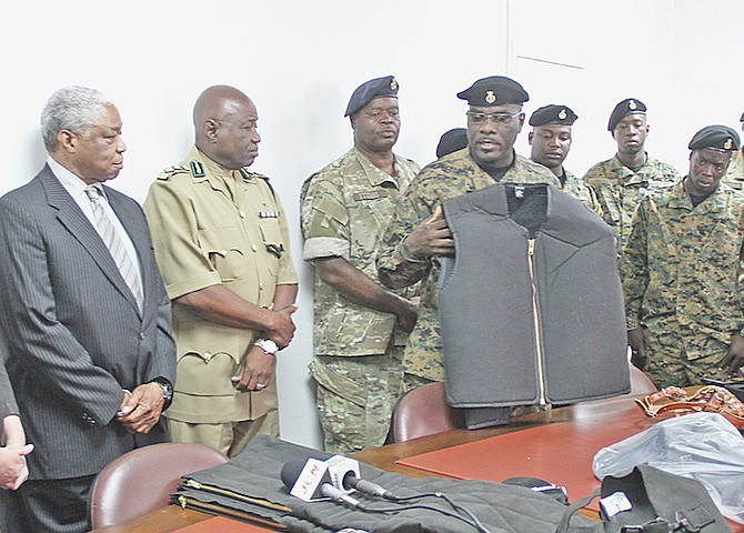 Corrections Officer David Rolle explains the use of some of the items that have been donated to The Bahamas by the US Embassy, as Minister of National Security Dr Bernard Nottage watches on yesterday.