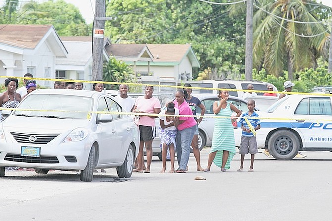 A family member is consoled at the scene of yesterday’s shooting of a young man in Nassau Village.
Photo: Tim Clarke/Tribune staff