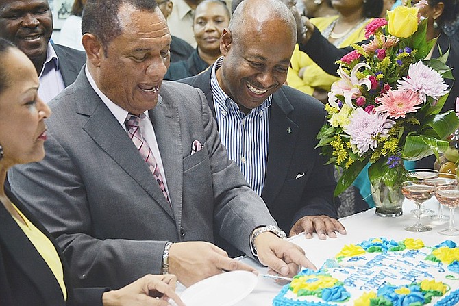 Minister of Tourism Obie Wilchcombe pictured with Prime Minister Perry Christie earlier this year, cutting a cake to celebrate Mr Christie’s 40 years in public service. 

Photo: Shawn Hanna/Tribune Staff