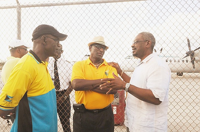 V Alfred Gray MP, centre, speaking to Dr Hubert Minnis at Long Island yesterday. 