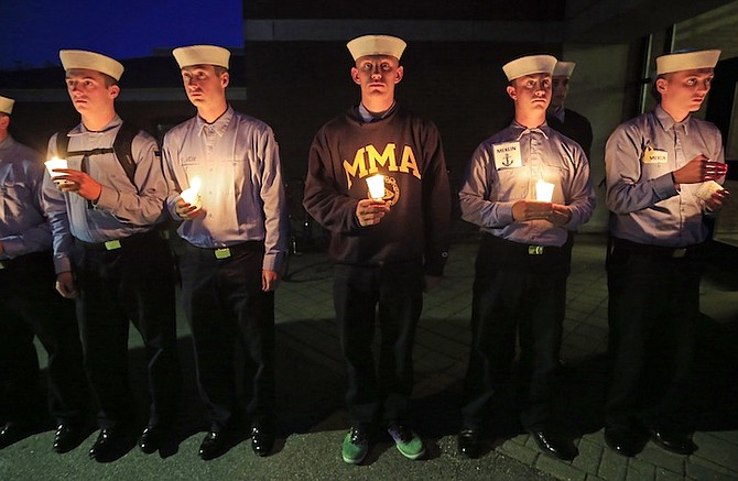 Maine Maritime Academy students attend a vigil of hope for the missing crew members of the U.S. container ship El Faro, Tuesday evening. (AP Photo/Robert F. Bukaty)