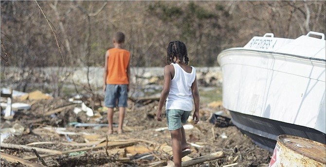 Youngsters on Long Island yesterday exploring the wreckage following Hurricane Joaquin. 
Photo: Shawn Hanna/Tribune Staff