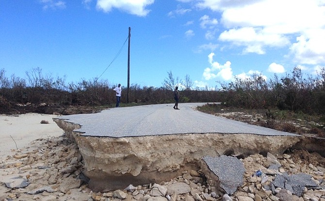 The road at Winding Bay washed away .