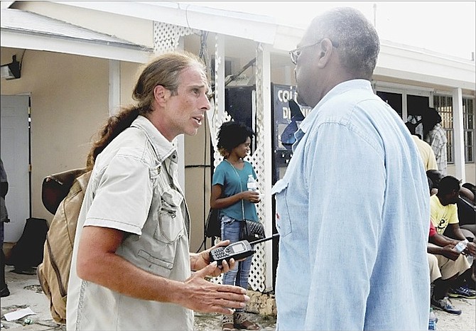 Darren Adler, a British disaster relief expert with HOPE, explains the gravity of the situation on Crooked Island to Dr Hubert Minnis when the leader of the Free National Movement arrived on October 5. 	Photo/Yontalay Bowe