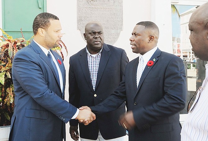 New FNM members Andre Rollins, left, and Renward Wells shaking hands outside the House of Assembly. Photo: Yontalay Bowe/FNM