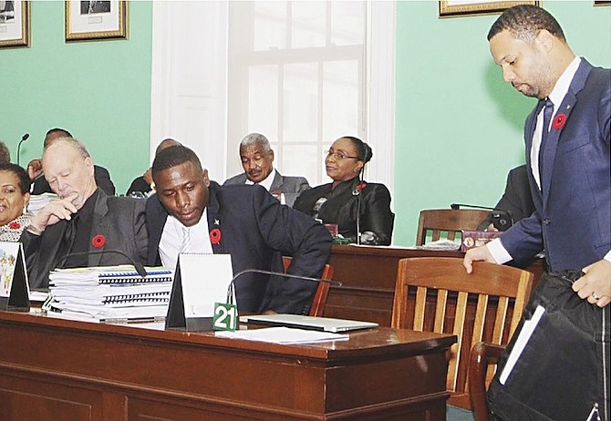 Renward Wells and Andre Rollins, right, take their seats alongside their new FNM colleagues yesterday. 
Photo: Yontalay Bowe/FNM