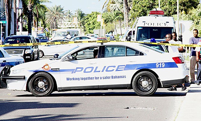 A POLICE car at the scene of one of the many shootings that has plagued The Bahamas, with a new record murder count having been set this year. 