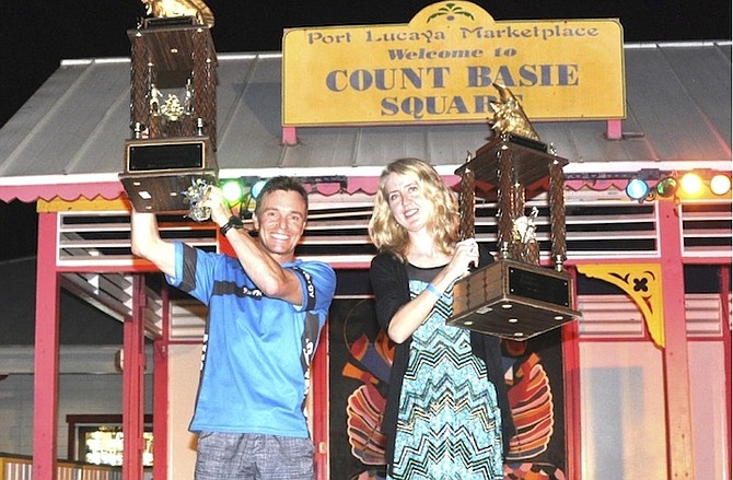 Stefan Laursen and Elizabeth Shaddock hold up their winner’s trophies at the Conchman Triathlon.

