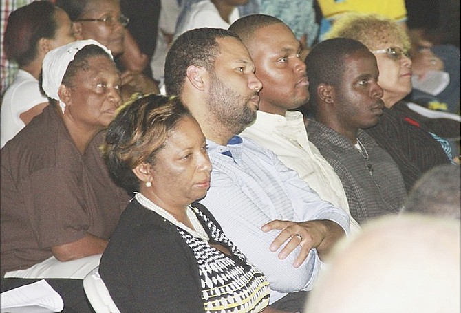 Dr Andre Rollins, centre, among the crowd at the anti-crime rally at St Gregory’s Church last night.