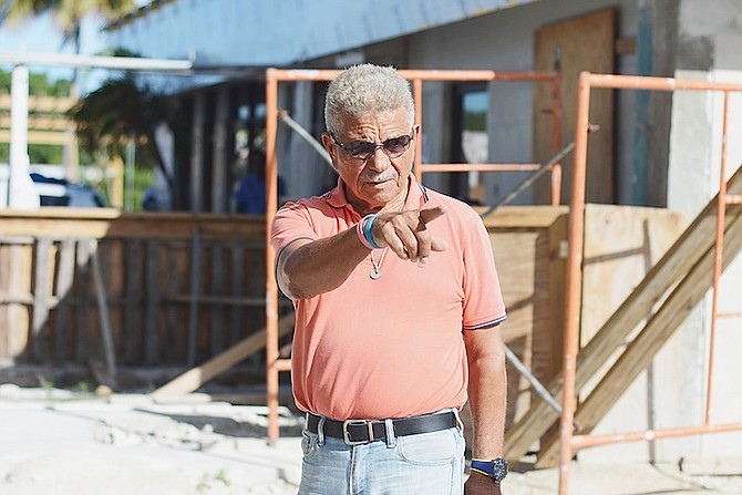 Peter Roker, owner of Bargain City Plaza, showing the construction under way of a gas station. Photos: Shawn Hanna/Tribune Staff