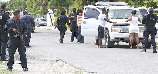 Armed officers in Nassau Village yesterday afternoon as police locked down Nassau Village following the latest murder in The Bahamas, the 134th this year. Photo: Tim Clarke/Tribune Staff