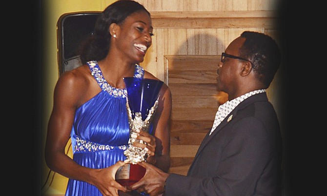 SHAUNAE MILLER receives the Prime Minister’s Award for Most Outstanding Athlete for 2015 from Minister of Youth, Sports and Culture Dr Daniel Johnson.