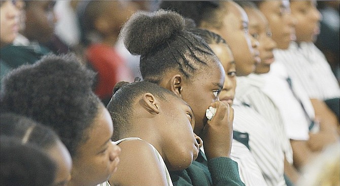Children mourning Joyelle McIntosh at an assembly in 2015 following the death of the Queen’s College teacher. 