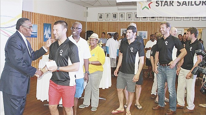 AWARDS CEREMONY: Minister of Agriculture, Marine Resources and Local Government V Alfred Gray presents awards to international sailors at the Star Sailors League ceremony at Nassau Yacht Club yesterday.
Photo by Tim Clarke/Tribune Staff