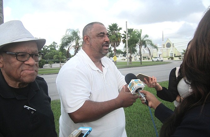 
Troy Garvey reports to the media after his meeting with the Grand Bahama Power Company, watched by Etienne Farquharson. Photo: Denise Maycock/The Tribune
