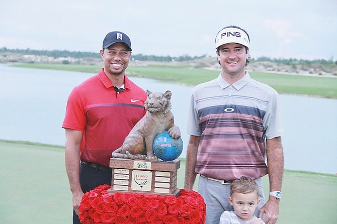 HERO WORLD CHALLENGE champion Bubba Watson and his son Caleb, share a special moment with tournament host Tiger Woods.