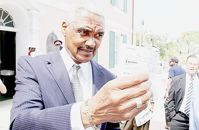 LESLIE Miller pictured last year showing the cheque for $1,000 he said he was giving to the Bahamas Crisis Centre after he had said in the House of Assembly that he had physically abused an ex-girlfriend, something he later said was a joke. The centre declined the offer of a cheque from Mr Miller. 
