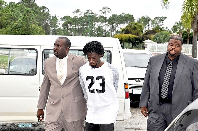 Philip Sweeting being escorted outside Freeport Magistrate’s Court yesterday. Photo: Vandyke Hepburn