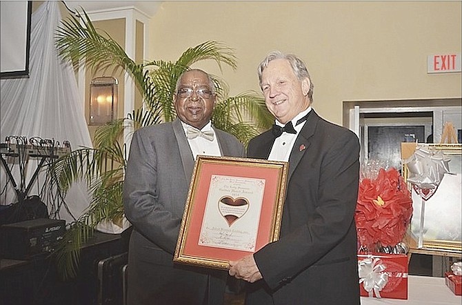 Chairman of the Sassoon Heart Foundation R E Barnes (right) presents A Bismark Coakley with this year’s Lady Sassoon Golden Heart award. 										        
Photo/Jamal Jones