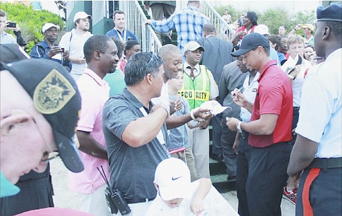 PRO GOLFER Tiger Woods signs autographs during the Hero World Challenge at Albany Golf Course.
Photo by Tim Clarke/Tribune Staff