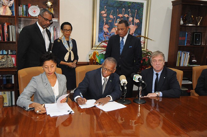 Seated, from left, Candia Ferguson, Cabinet secretary Wendall Major and Pierfrancesco Vago, executive chairman of MSC. Standing are Jerome Fitzgerald MP, Attorney General Allyson Maynard-Gibson and Prime Minister Perry Christie. 

PHOTO: Peter Ramsay/BIS