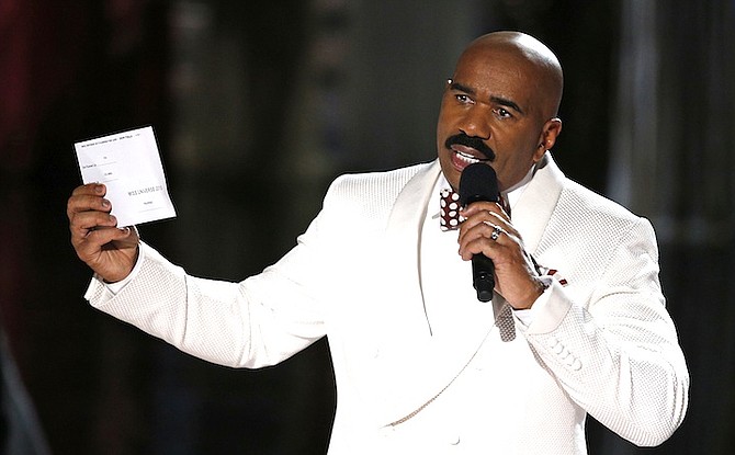 Steve Harvey holds up the card showing the winners after he incorrectly announced Miss Colombia Ariadna Gutierrez at the winner at the Miss Universe pageant Sunday. (AP)