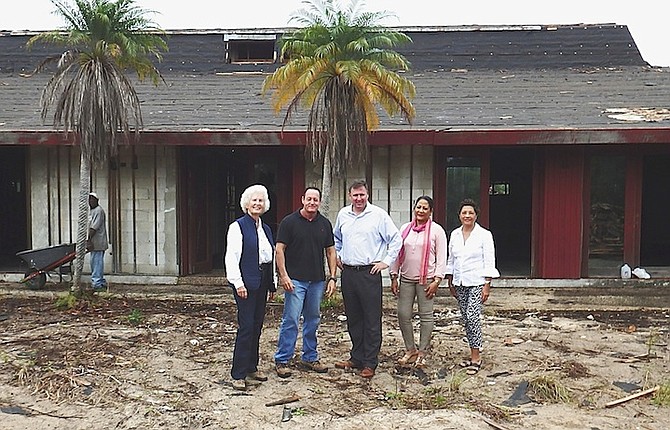 Reviewing the demolition of the old roof on the site of the Museum of Grand Bahama are Erika Gates, Bruce Silvera, of the Freeport Construction Company, Michael Clough, Chantal Bethel and Janet Albury.