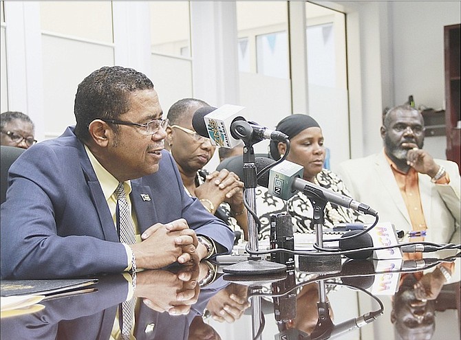 minister of Health Dr Perry Gomez speaking at the signing of a five-year industrial agreement yesterday. Pictured second right is Bahamas Nurses Union president Jannah Khalfani. Photo: Tim Clarke/Tribune Staff