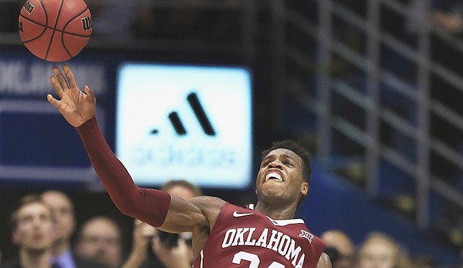 Oklahoma guard Buddy Hield (24) tries a full-court shot at the end of the second half of an NCAA college basketball game against Kansas in Lawrence, Kan., Monday, Jan. 4, 2016. Hield scored 46 points in the game. Kansas defeated Oklahoma 109-106 in triple overtime. (AP Photo/Orlin Wagner)