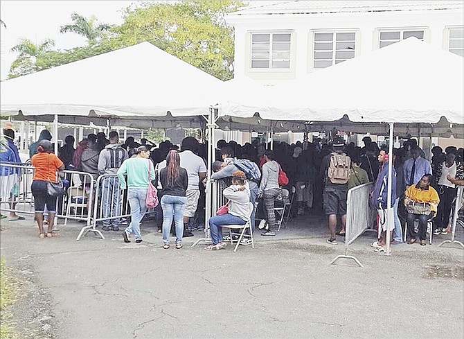 Long lines outside the College of The Bahamas yesterday despite the cold and the rain. 
Photos: Tim Clarke/Tribune Staff