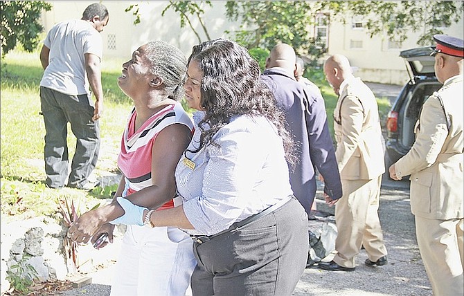 A family member is consoled at the scene after the death of a man near St Mary’s Hall. 
Photo: Tim Clarke/Tribune Staff