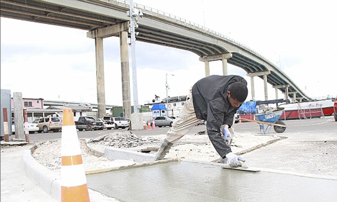 Work continuing as part of the redevelopment work in the Potter’s Cay Dock area. 
Photo: Tim Clarke/Tribune Staff